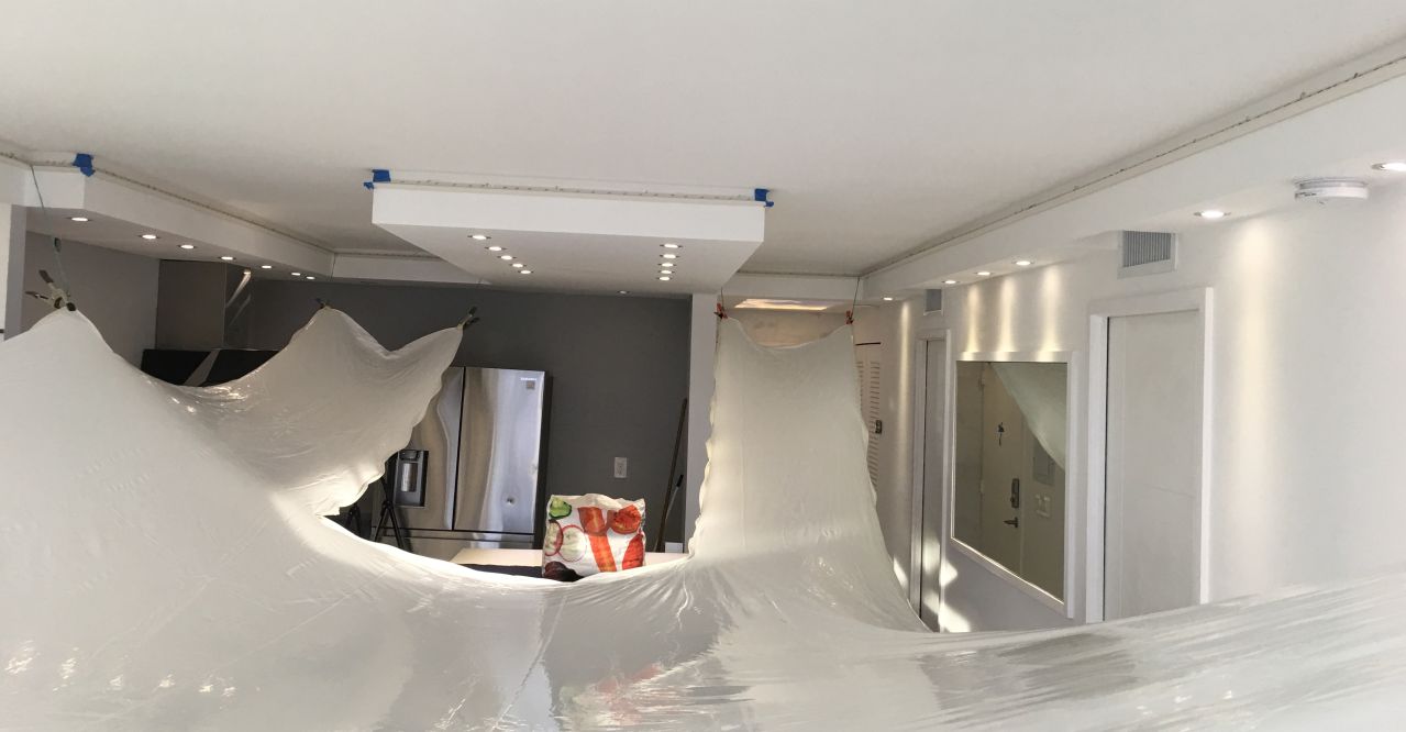 Stretch ceiling installation in progress in Hialeah showing PVC membrane being stretched